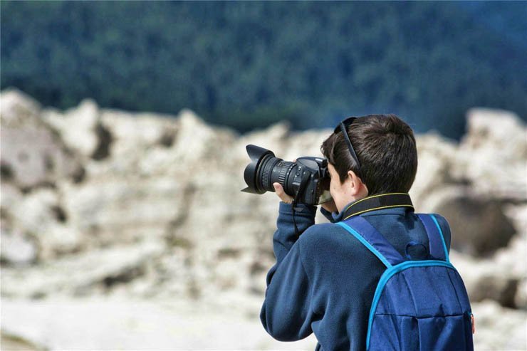 Photo camera photos boy kid child rock sea water ocean back take taking pictures picture photography photographer