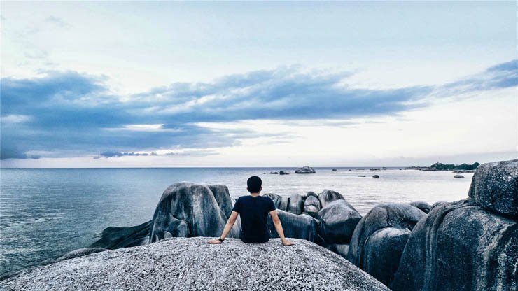 Solitary rock rocks sky sea water ocean stone stones
