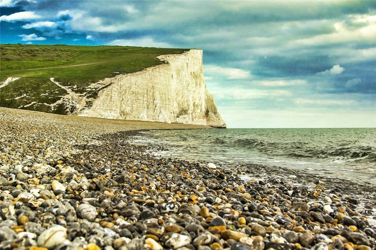 cliff sea shore beach rock stone sky ocean sea