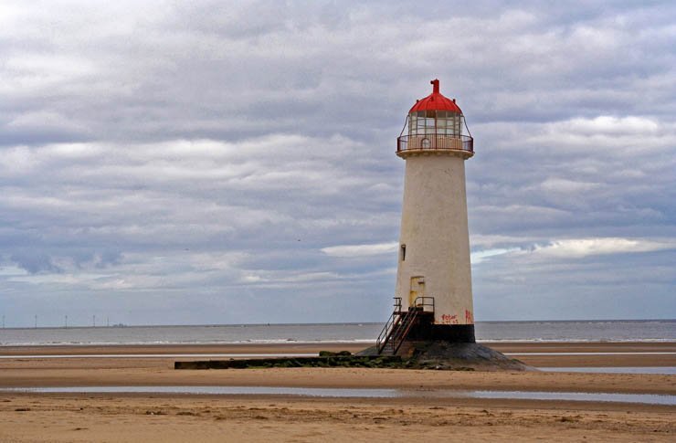 light house lighthouse water island ocean sea mountain sky beach sand cloud clouds cloudy