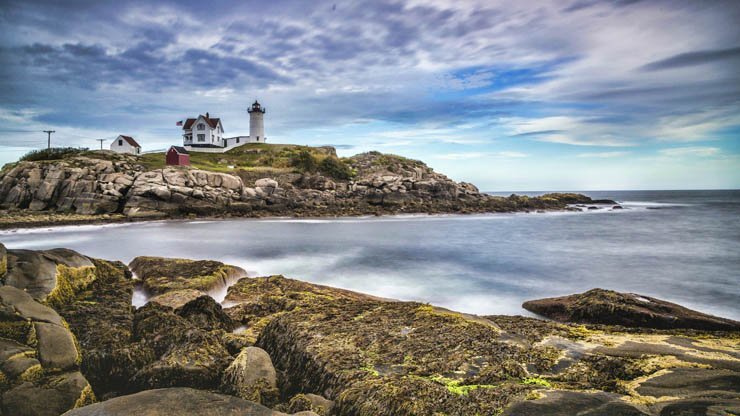 light house lighthouse water island ocean sea mountain sky cloudy clouds cloud