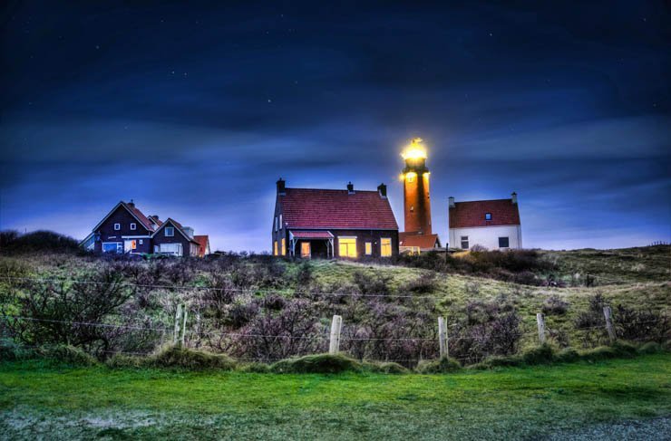 light house lighthouse water island ocean sea mountain sky night evening