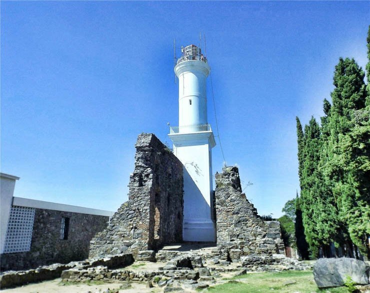 light house lighthouse water island ocean sea mountain sky tree trees