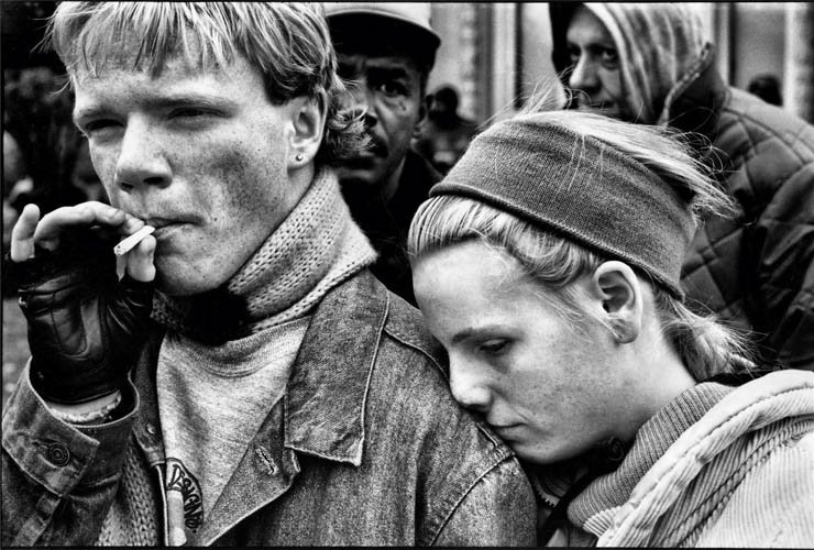 man woman couple love care worry smoking cigarette crowd black white sad