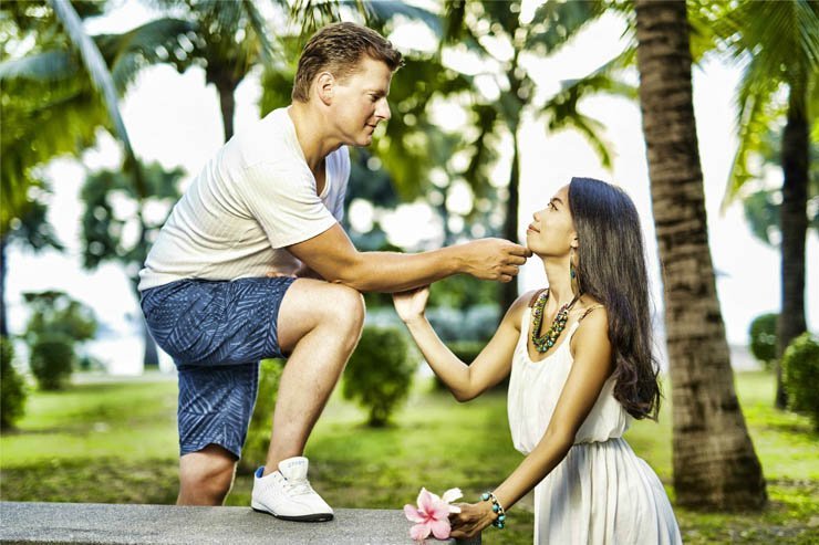 man woman couple summer happy love romance romantic pose flower palm tree
