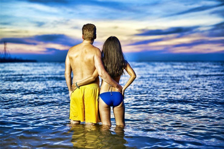man woman swim suit swimming couple romantic sunset sea ocean love