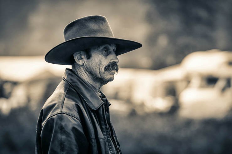 old man black white hat leather mustache