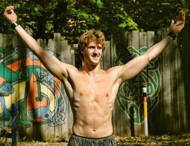 topless man male boy graffiti outdoor happy spread arm arms play playing park street handsome